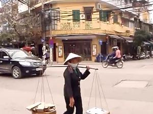A walk through a heavily trafficked steet in the Old Quarter in Hanoi, Vietnam